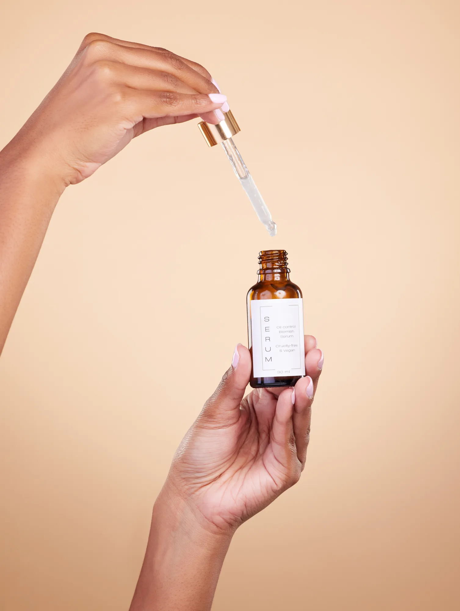 A beauty facial serum dropper being opened.
